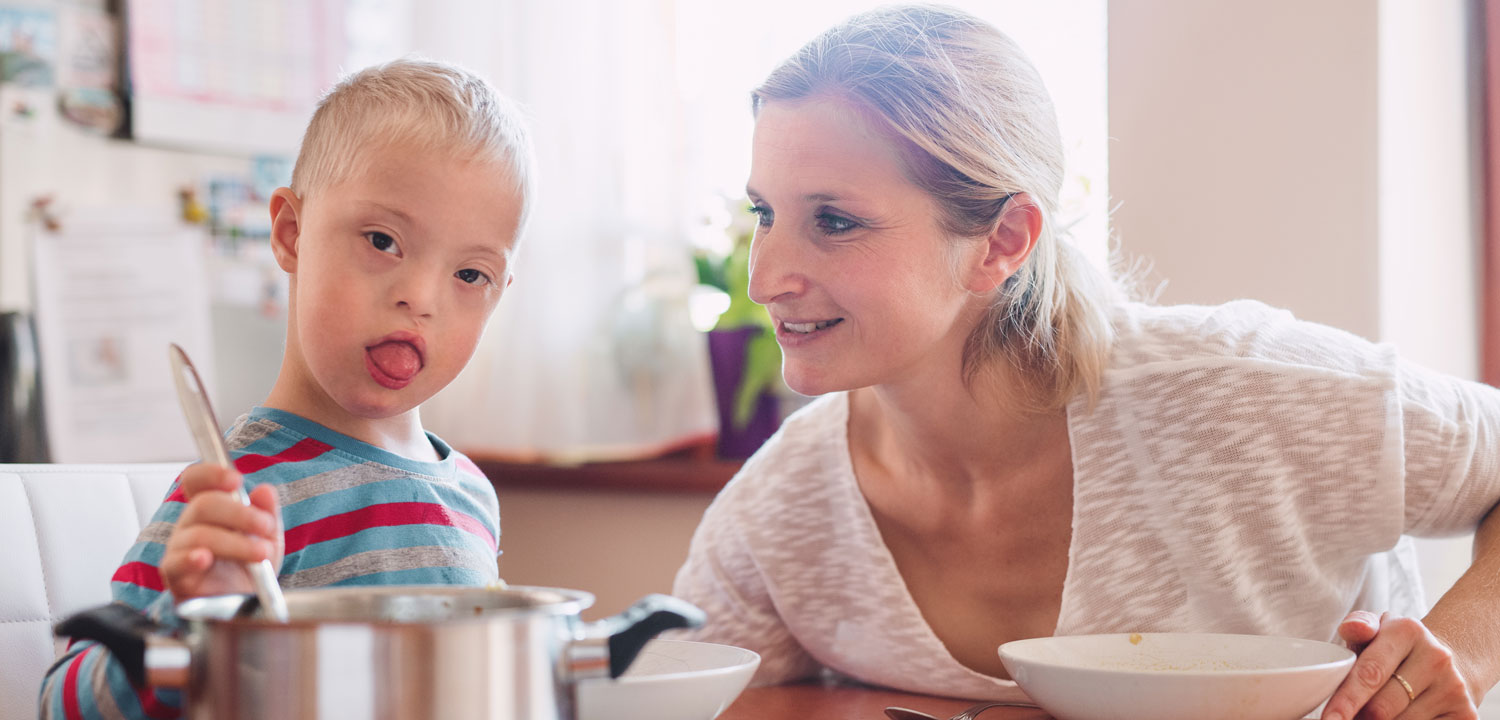 A child with developmental disabilities helping with a meal